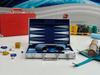 Portable aluminum frame backgammon set with folding board and smooth playing surface